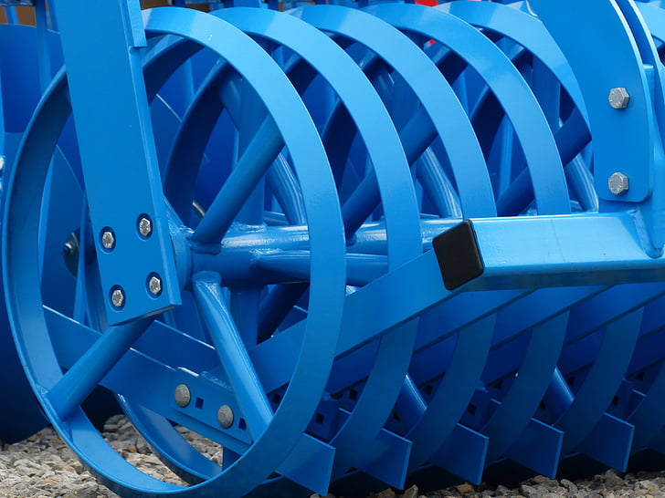 selective focus photography of blue cultivator blade