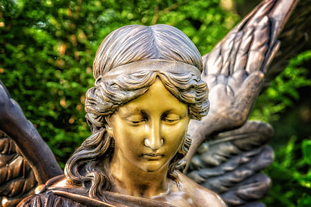 brass-colored statue of angel