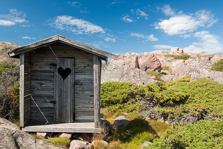 brown wooden shed on mountains