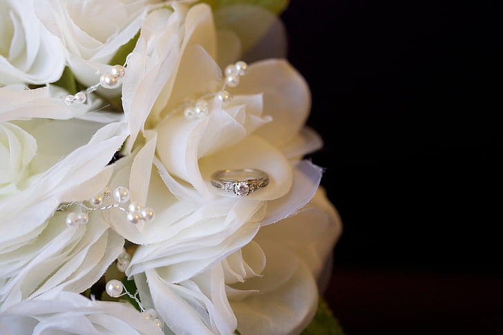 silver-colored ring on white bouquet