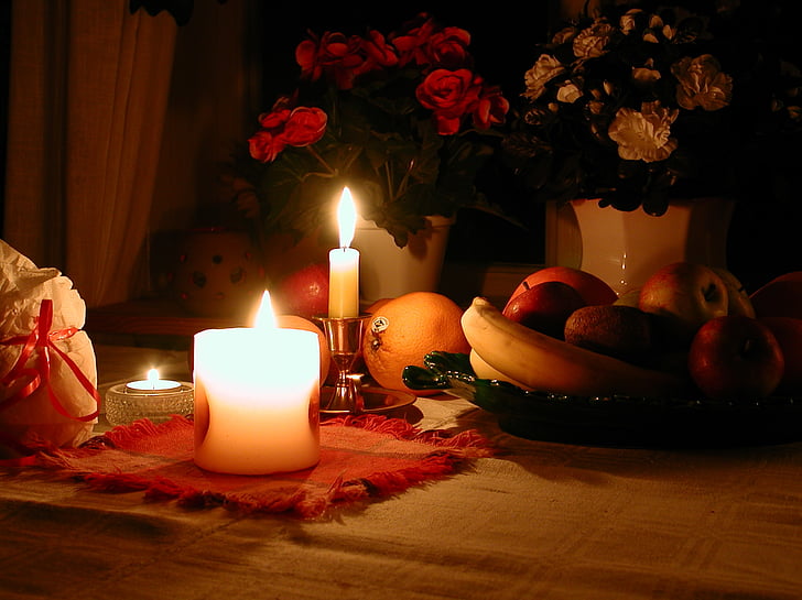 lighted candles beside fruits