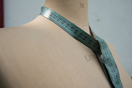 blue tape measure on beige mannequin