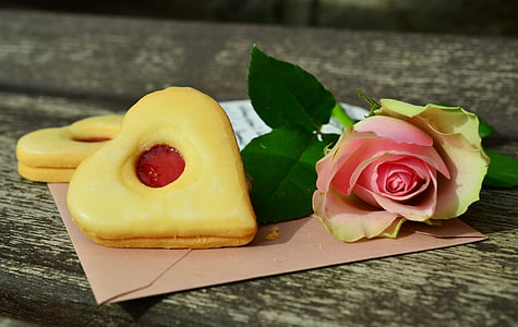pink rose flower with two cookies
