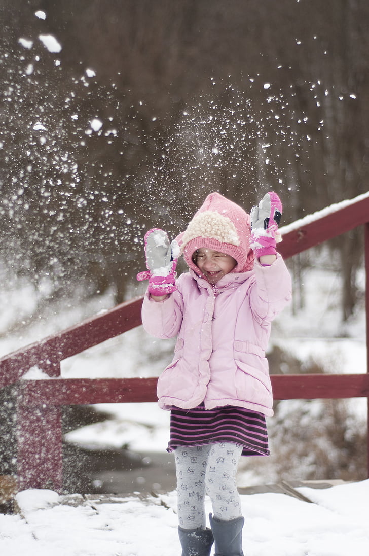 girl playing on snow