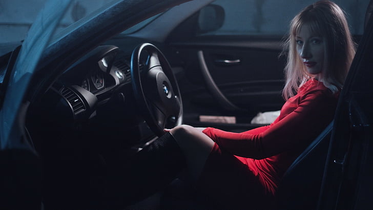 woman in red top inside a car
