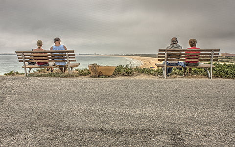 four person sitting on two benches