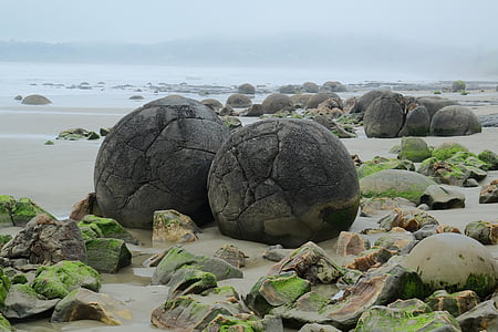 two round gray stones at beach during daytime