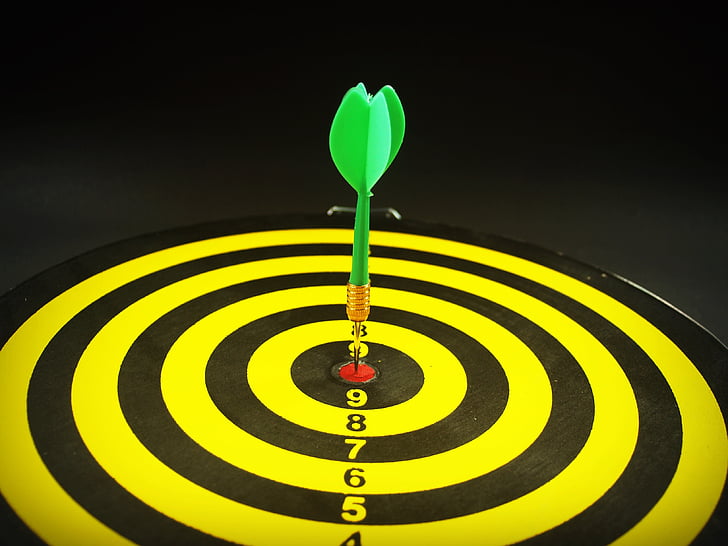 green dart pin on dartboard bullseye