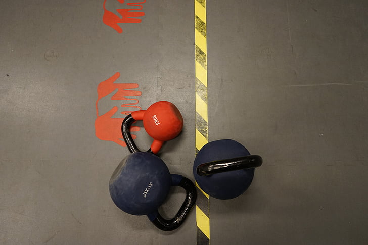 three assorted-color kettle dumbbells