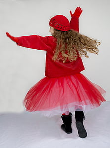 girl in red coat, tutu skirt, and hat