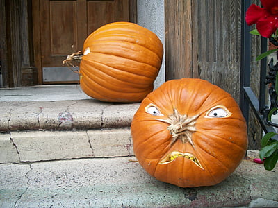 two pumpkins beside door