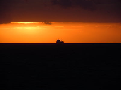 silhouette of fishing boat during sunset