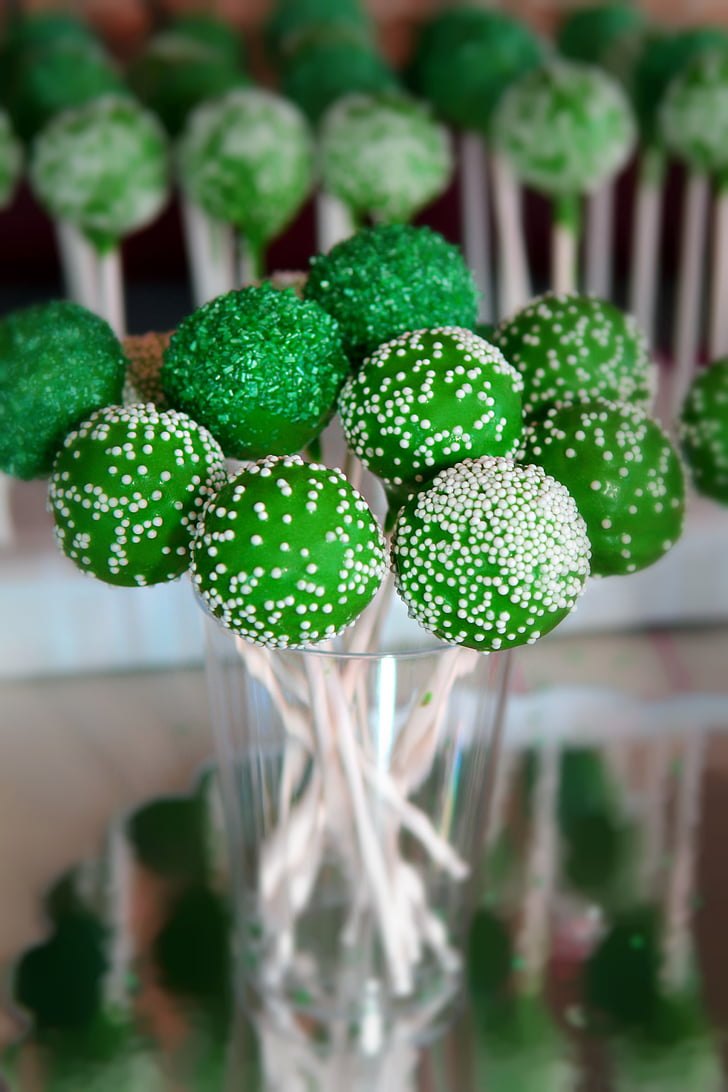 selective focus photography of green lollipops