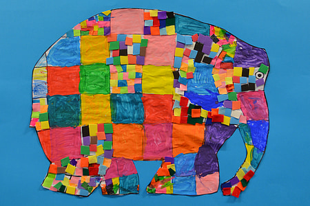yellow and blue elephant cutout artwork with blue background