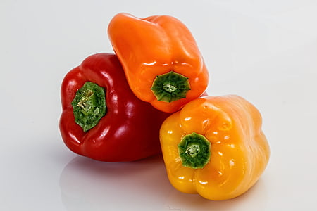 three red, orange, and yellow bell peppers