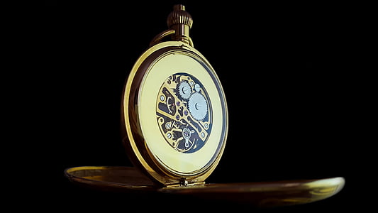 round gold-colored pocket watch