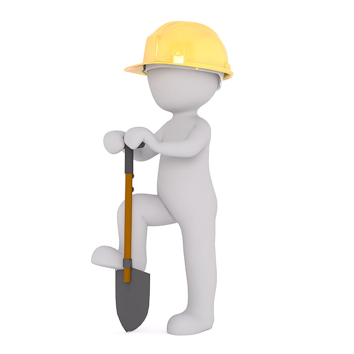 person wearing yellow hard hat holding shovel