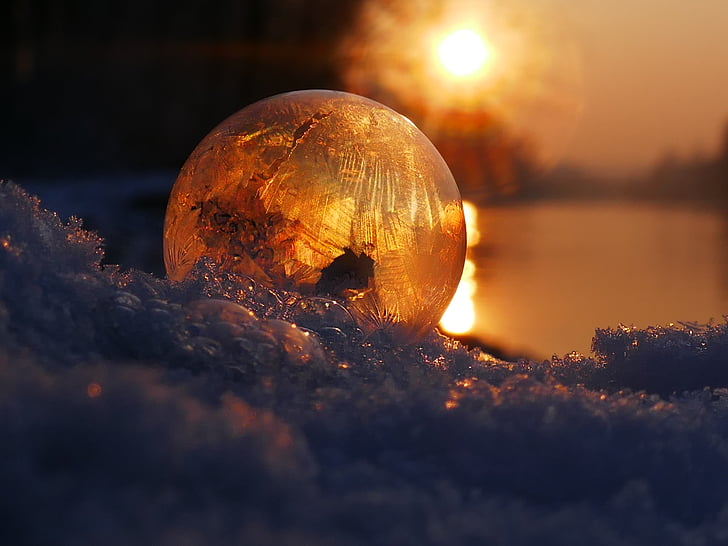 amber glass ball on snow