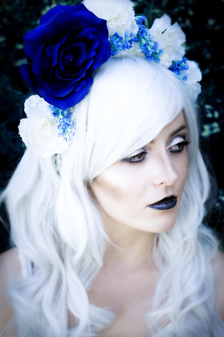 photo of woman wearing blue rose headdress