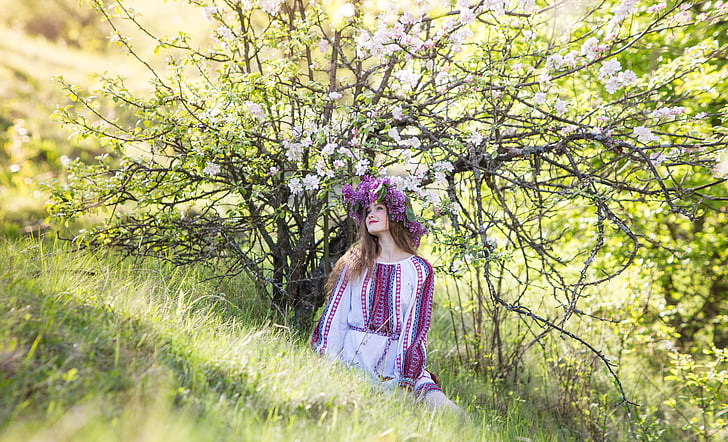 girl standing near white cherry blossom tree