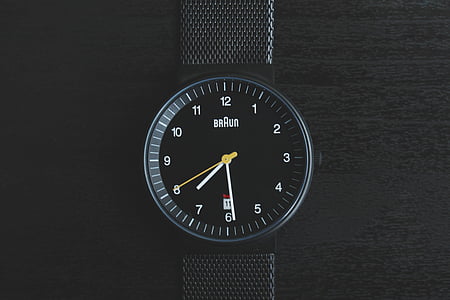 round black Braun analog watch at 7:29