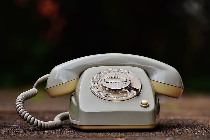 selective focus photography of rotary telephone
