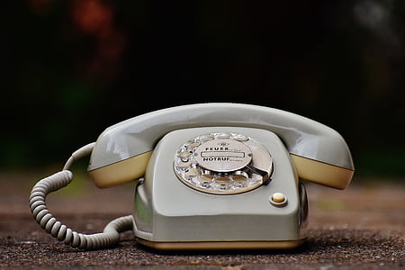 selective focus photography of rotary telephone