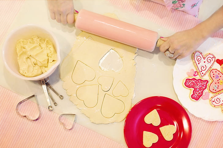 pink rolling pin near red plate