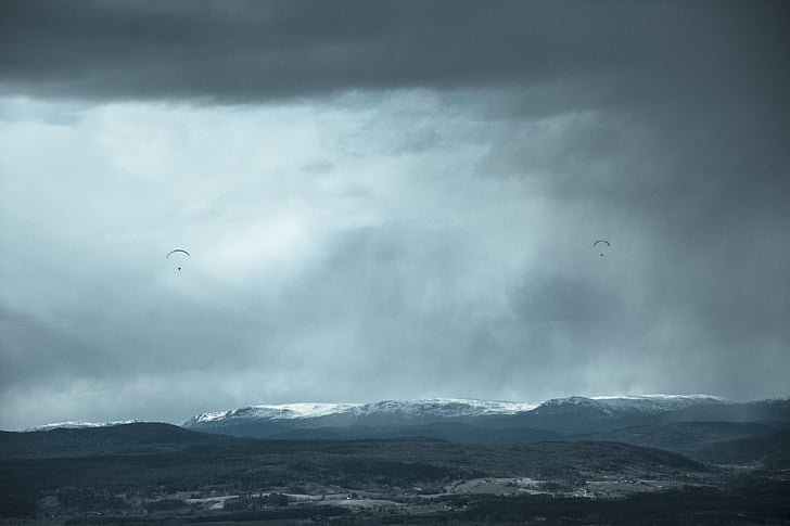 landscape photography of two parachuters