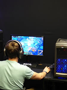boy holding computer mouse while playing MMORPG game