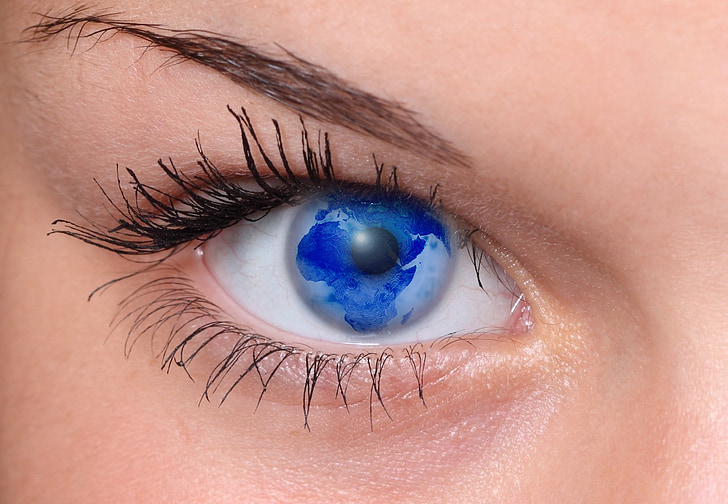 close-up photo of woman's eyes with blue earth reflection