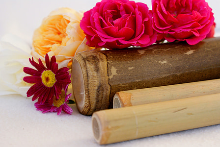 pink flowers on brown wooden tube