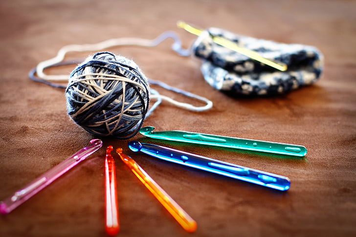 crochet ball and five assorted-color crochet sticks