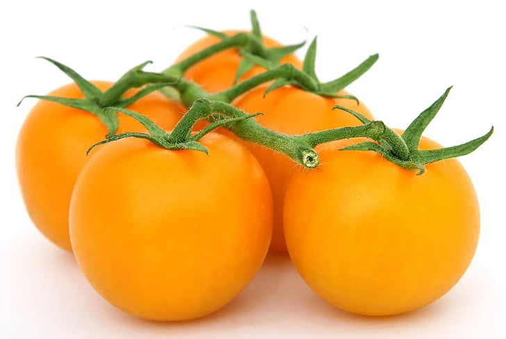 five orange cherry tomatoes