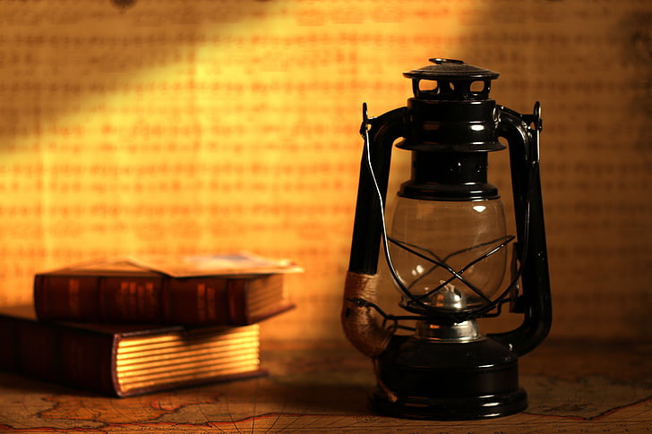 kerosene lantern beside books