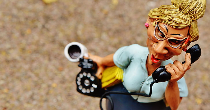woman holding telephone figurine