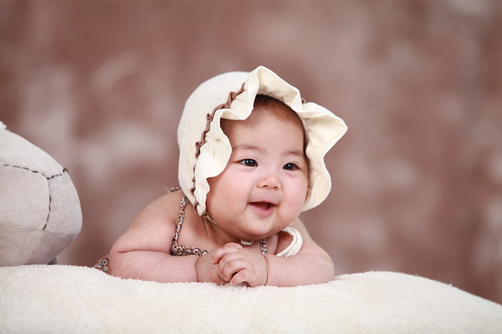 baby wearing beige hat