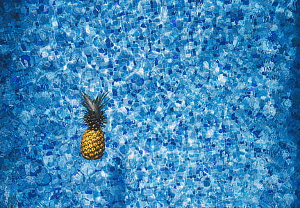 pineapple floating on body of water