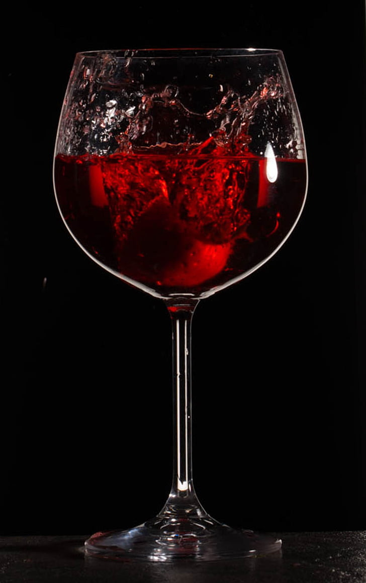 clear long-stem wine glass with red liquid
