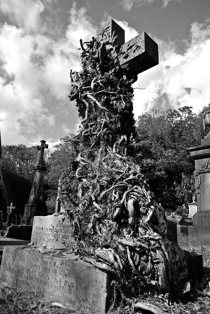 grayscale photo of cross on graveyard