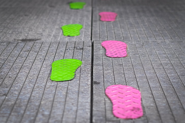 selective focus photography of green and pink footprints
