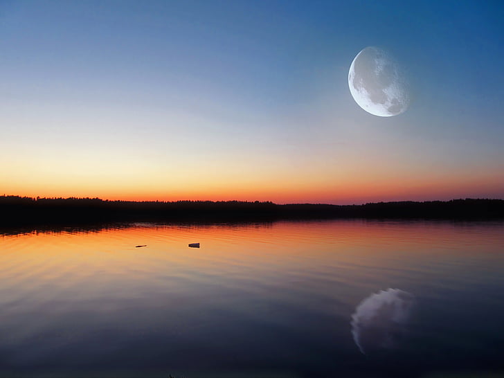 calm body of water under full moon