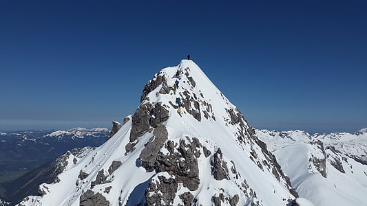 person standing on mountain peak