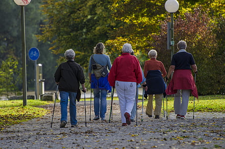 adult women with walking canes walking along street during daytime