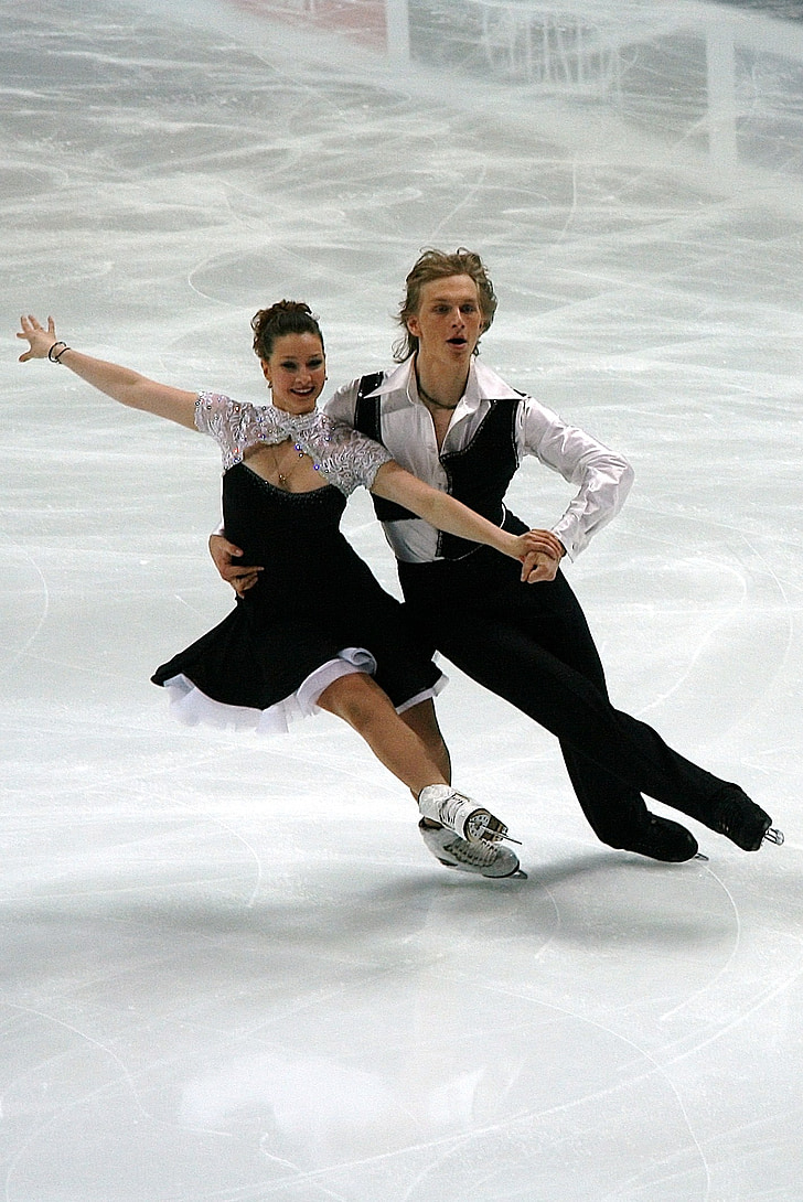 man and woman performing ice skating dance