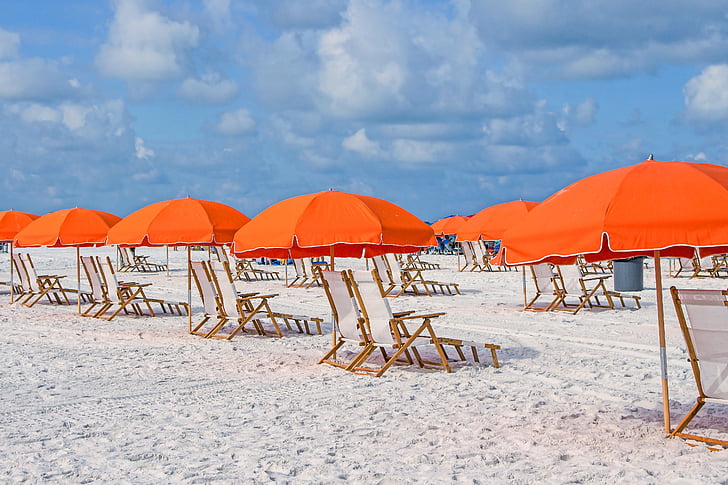 sun loungers with orange umbrellas