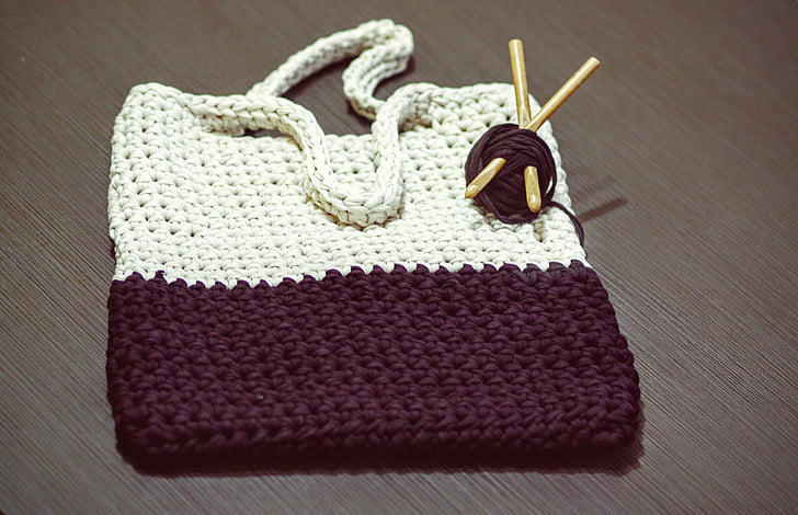 white and black knit bag