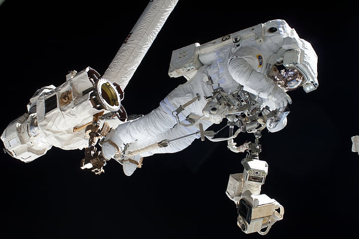 astronaut fixing machine on space