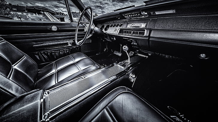 grayscale photography of classic vehicle interior