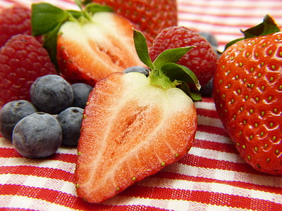 closeup photo of pile of strawberries and blueberries